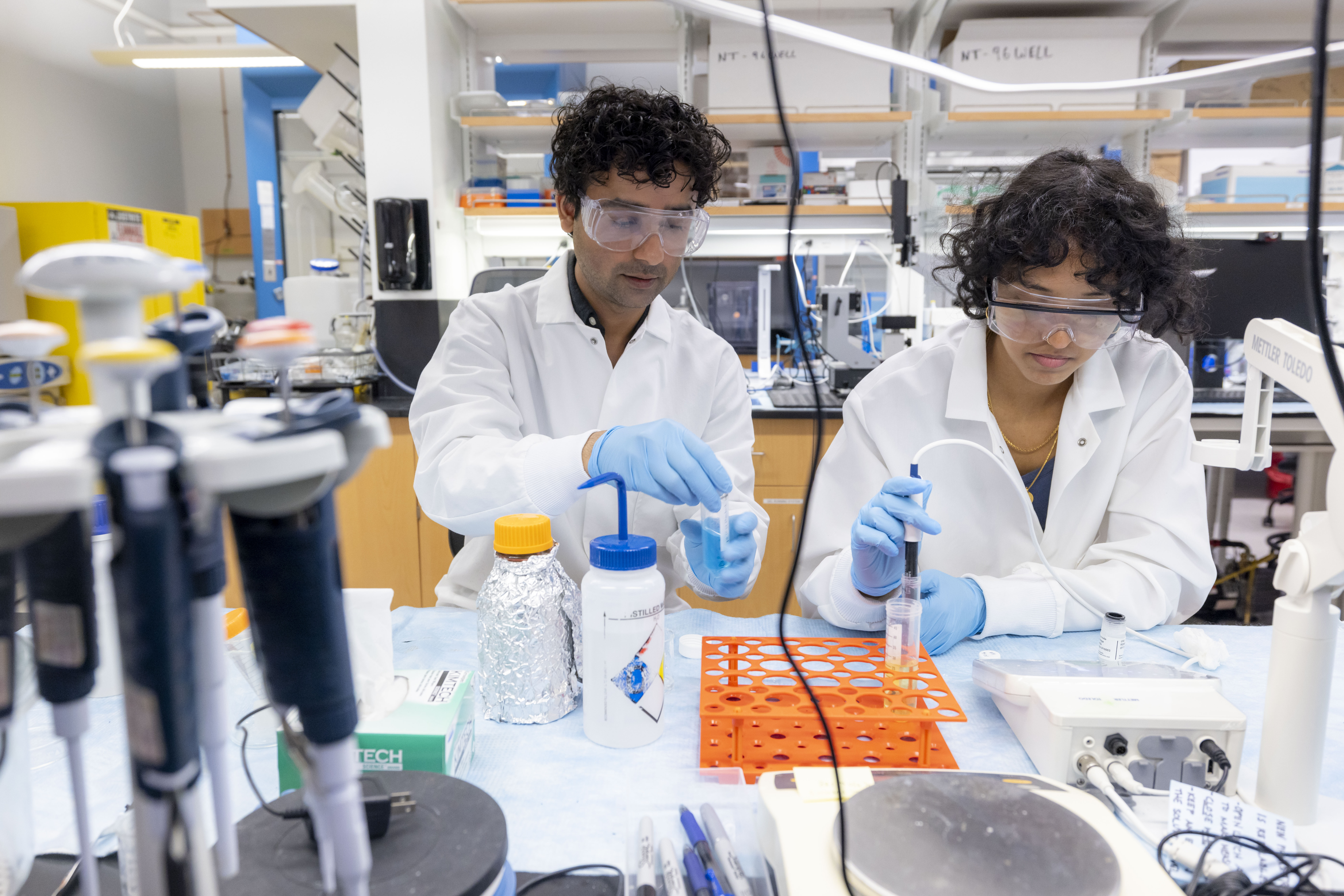 A student assists Dr. Indranath Mitra in the Bio-adaptable Musculoskeletal Materials Lab at William & Mary. (Photo by Timothy Sofranko)