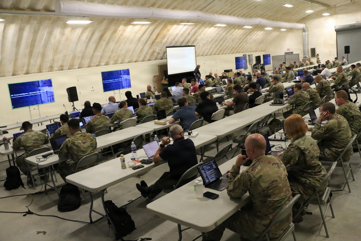 Civilian and military personnel listen to a class on operational technology security as part of Cyber Fortress 26 at the State Military Reservation in Virginia Beach. (U.S. National Guard photo by A.J. Coyne)