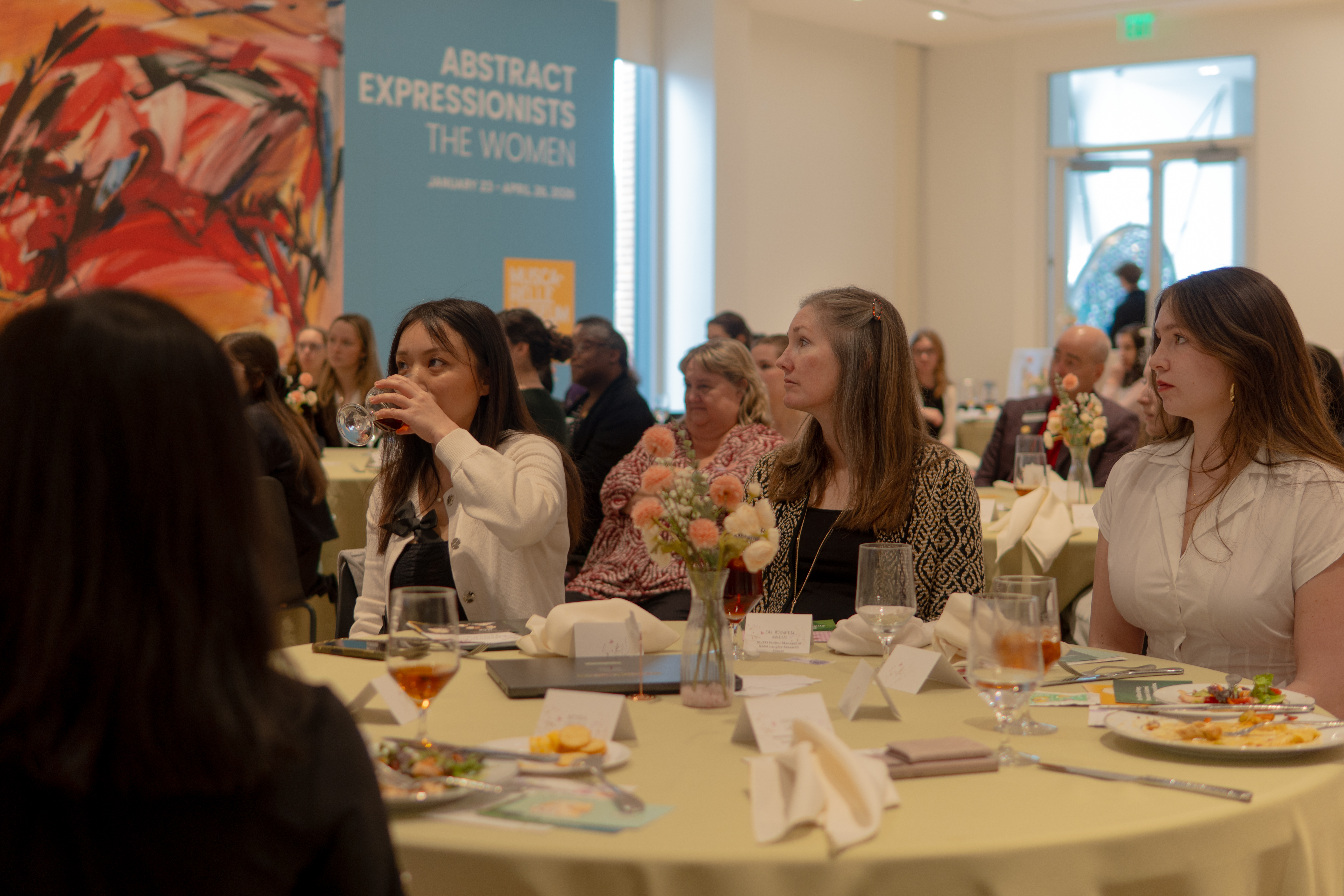 Jennifer Inman (center) and her mentee Solana Neeley (right) listen to a presenter at the MCP banquet. (Photo courtesy of Steven Tobar)
